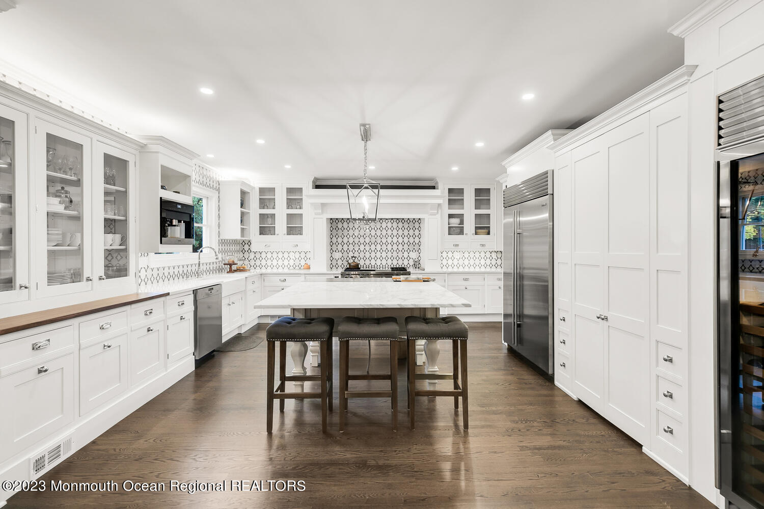 124 Rumson Road Rumson, NJ 07760 - Photo 4 of 52 a kitchen with stainless steel appliances granite countertop a table chairs sink refrigerator and cabinets