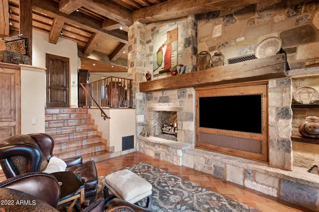 a living room with fireplace furniture and a flat screen tv