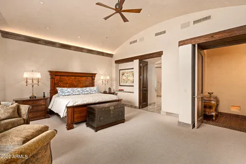 a bedroom with a bed and ceiling fan