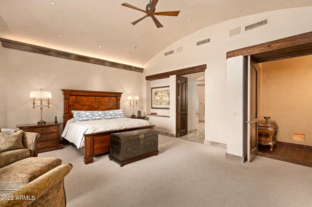 a bedroom with a bed and ceiling fan