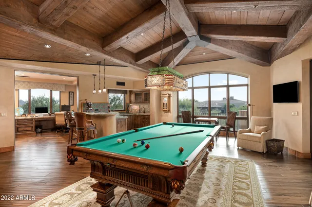 a room with pool table and a projector screen