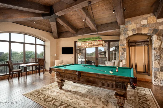 a backyard of a house with barbeque oven table and chairs