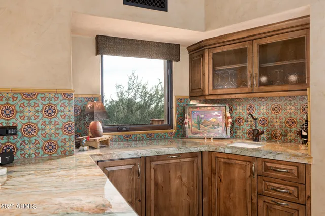 a kitchen with a sink wooden cabinets and a granite counter top