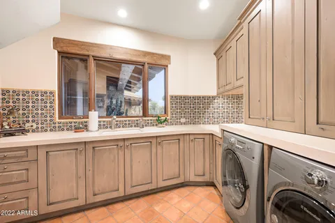 a view of a kitchen with washer and dryer
