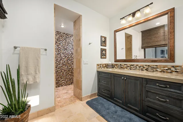 a bathroom with a sink a mirror and a shower