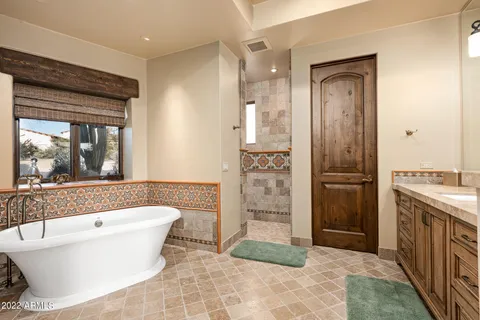 a bathroom with a bathtub and a shower