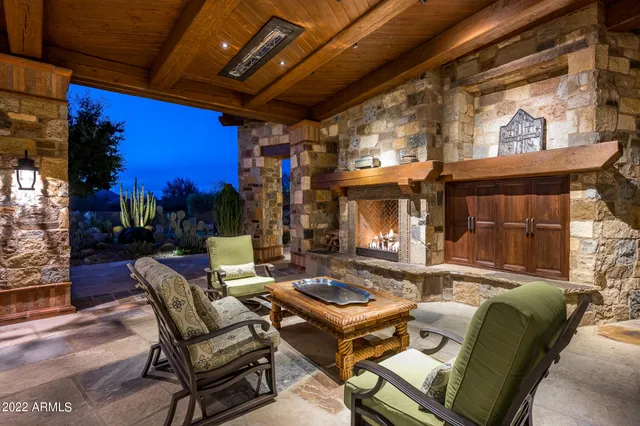 a outdoor living space with patio furniture and a fireplace