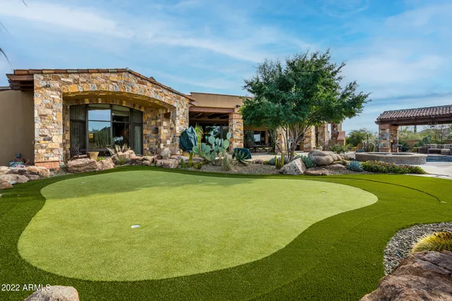 a view of a swimming pool with outdoor seating