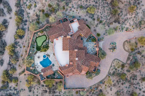 an aerial view of a house with outdoor space