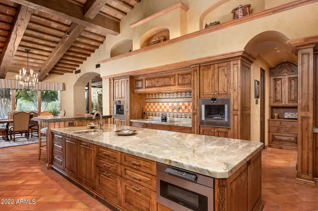 an open kitchen with granite countertop a sink and dishwasher a stove with wooden floor