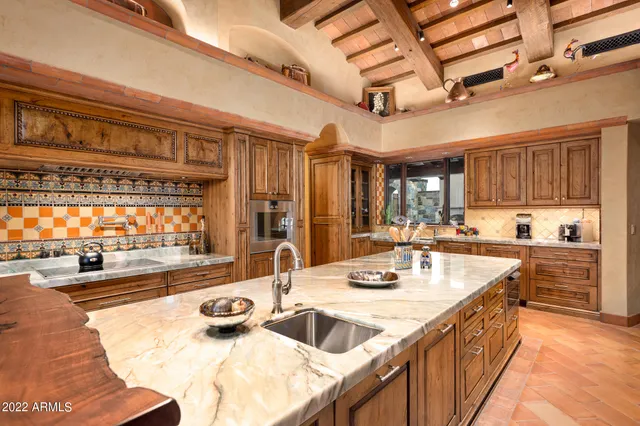 a kitchen with sink stove and cabinets