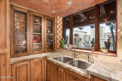 a view of a sink and a large mirror