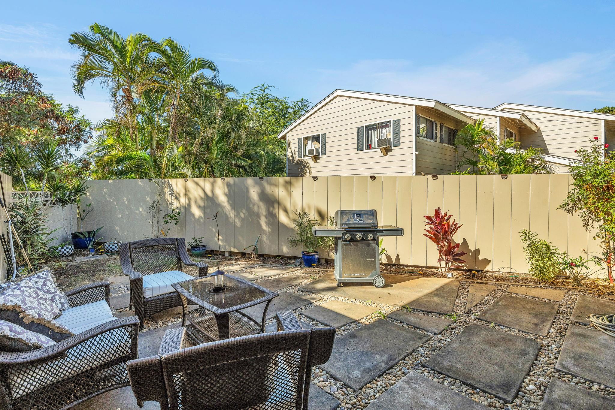 100 Auhana Road, Unit 103 Kihei, HI 96753 - Photo 16 of 43 a patio with table and chairs and potted plants
