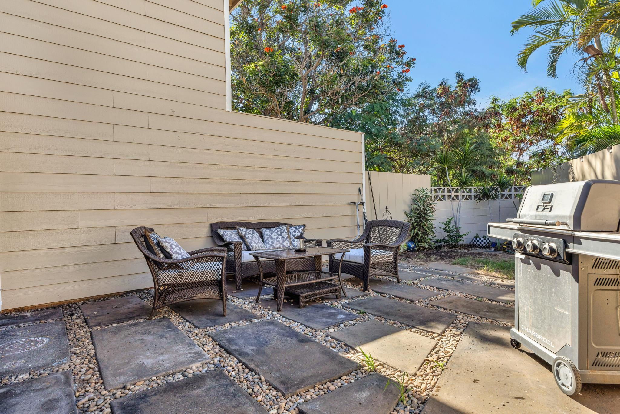 100 Auhana Road, Unit 103 Kihei, HI 96753 - Photo 17 of 43 a view of a patio with table and chairs with barbeque and a barbeque