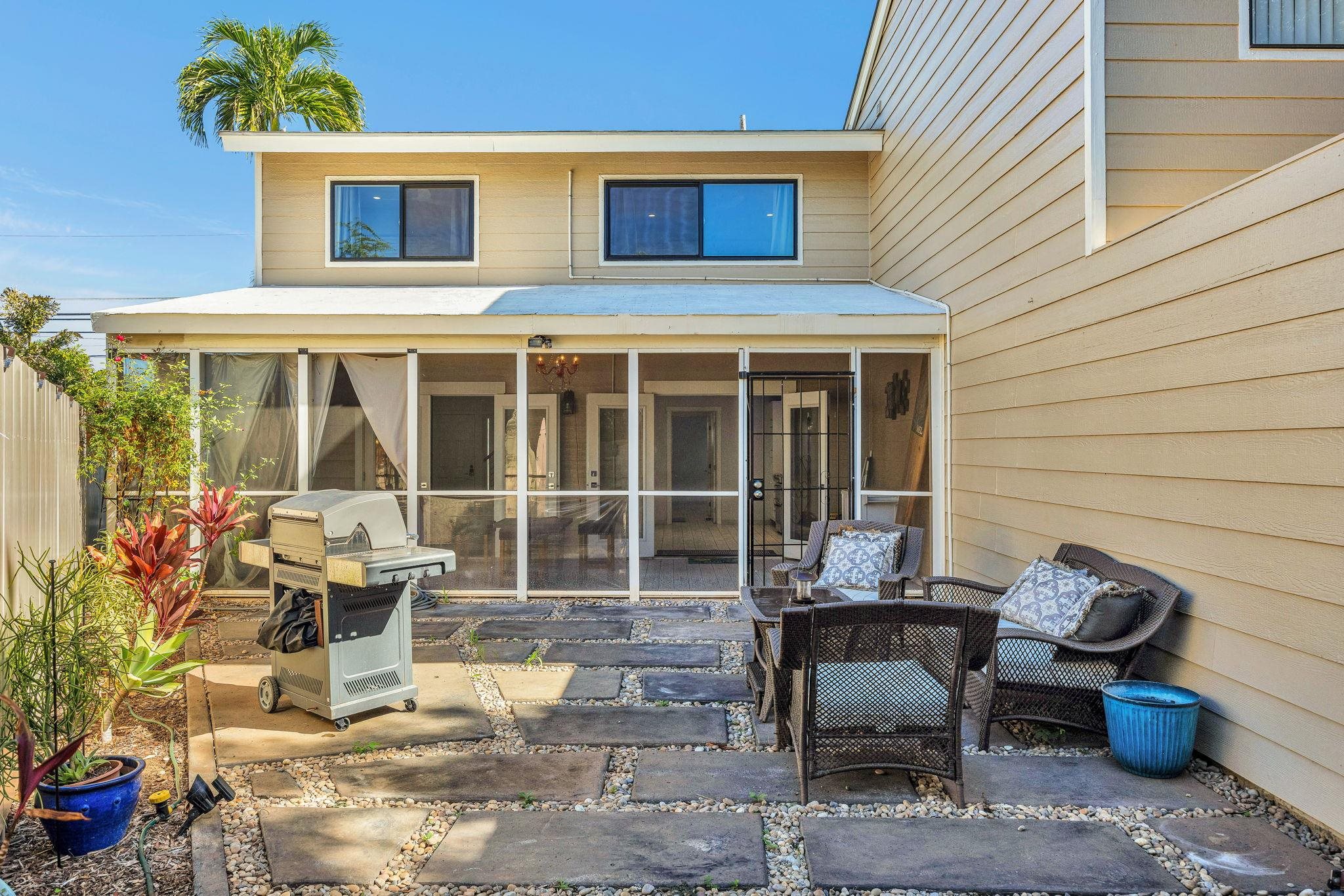 100 Auhana Road, Unit 103 Kihei, HI 96753 - Photo 18 of 43 a view of a patio with couple of chairs and potted plants