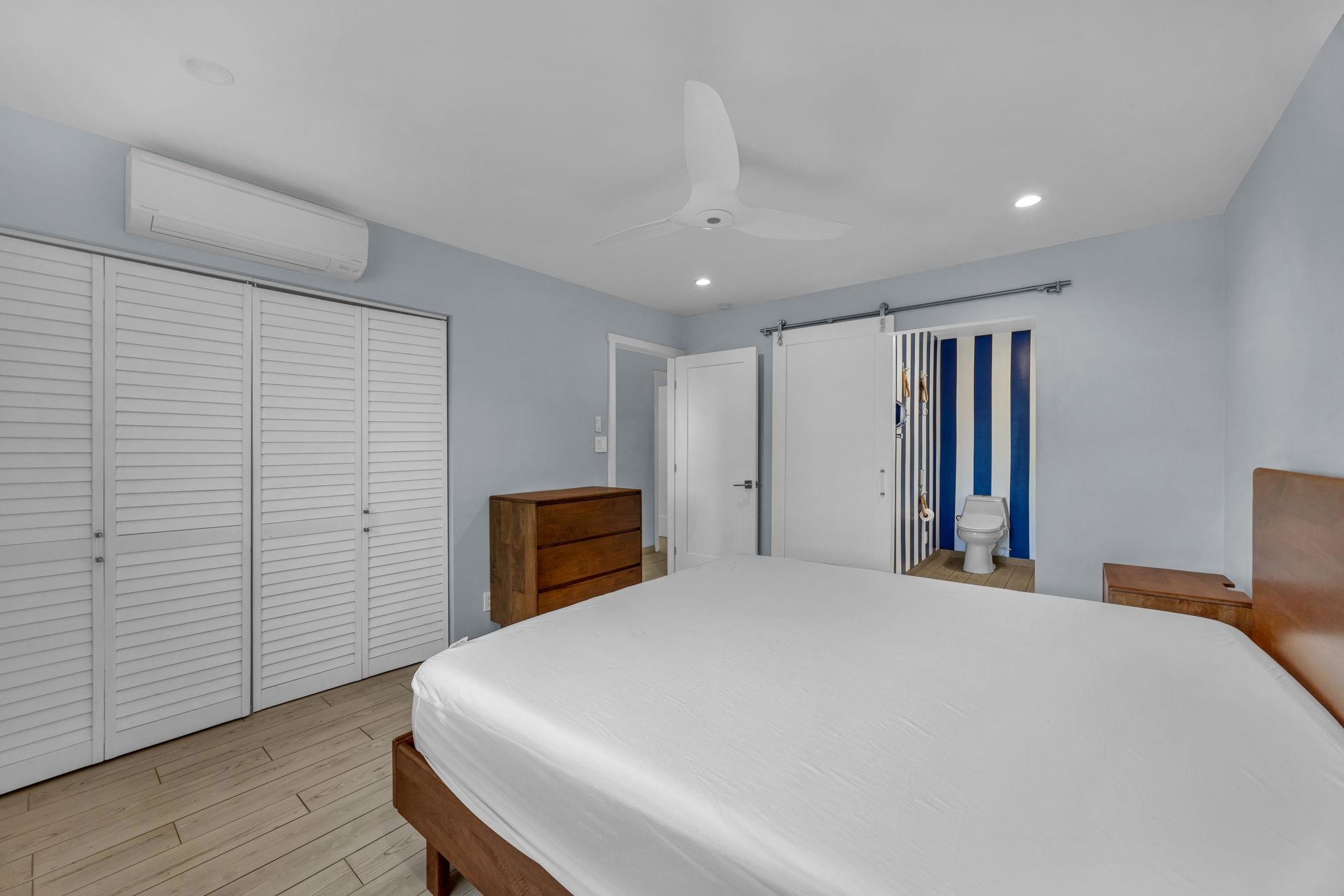 100 Auhana Road, Unit 103 Kihei, HI 96753 - Photo 28 of 43 a large bed sitting in a spacious bedroom next to a cabinet