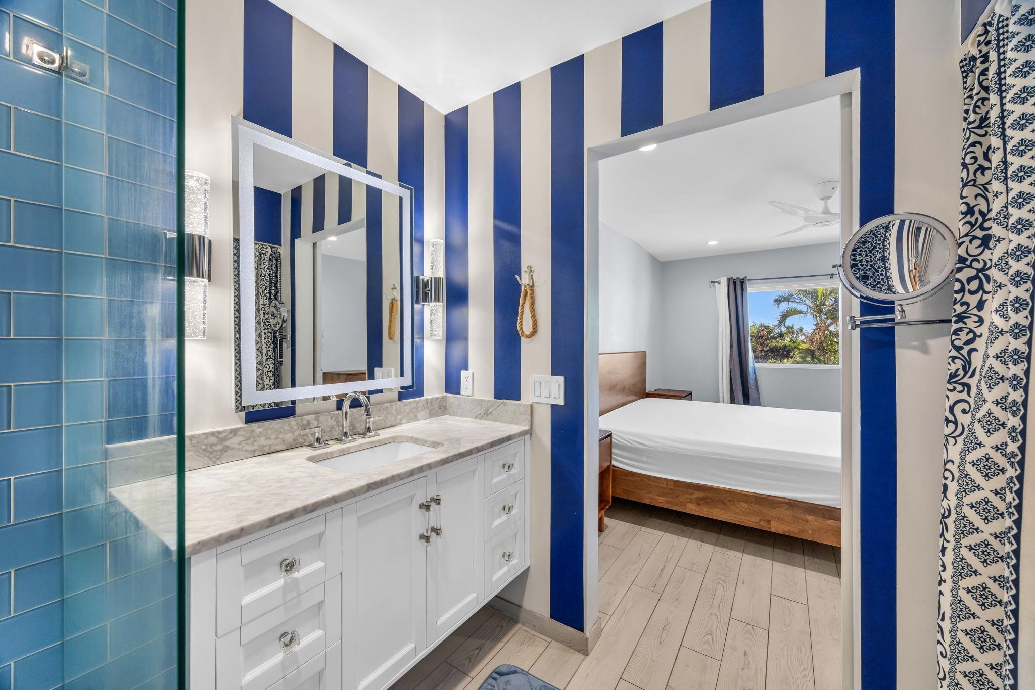 100 Auhana Road, Unit 103 Kihei, HI 96753 - Photo 30 of 43 a en suite bathroom with a double vanity sink a mirror and a shower