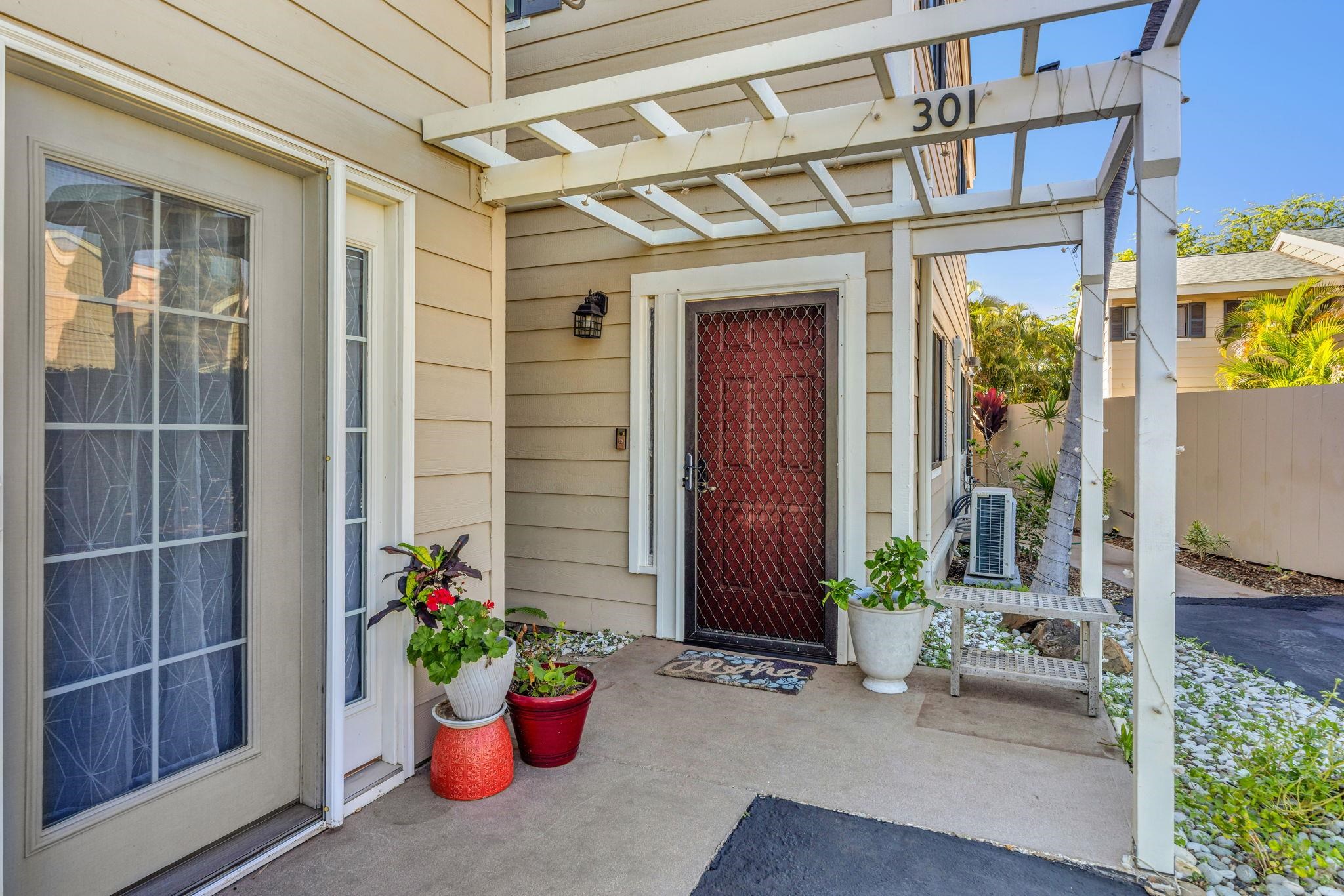 100 Auhana Road, Unit 103 Kihei, HI 96753 - Photo 4 of 43 a front view of a building with potted plants