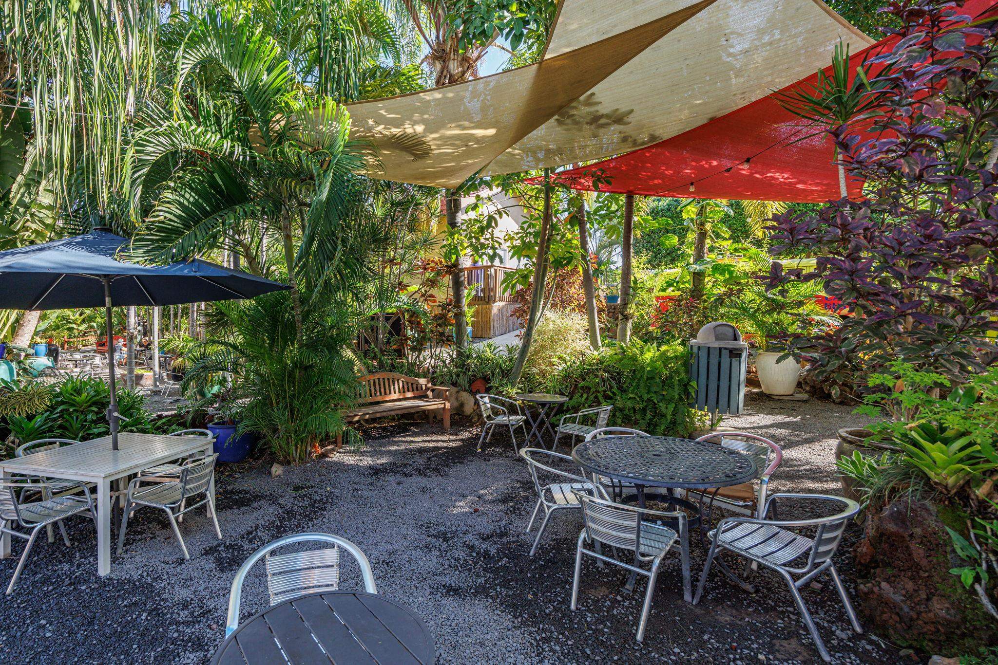 100 Auhana Road, Unit 103 Kihei, HI 96753 - Photo 41 of 43 a patio with a table and chairs under an umbrella