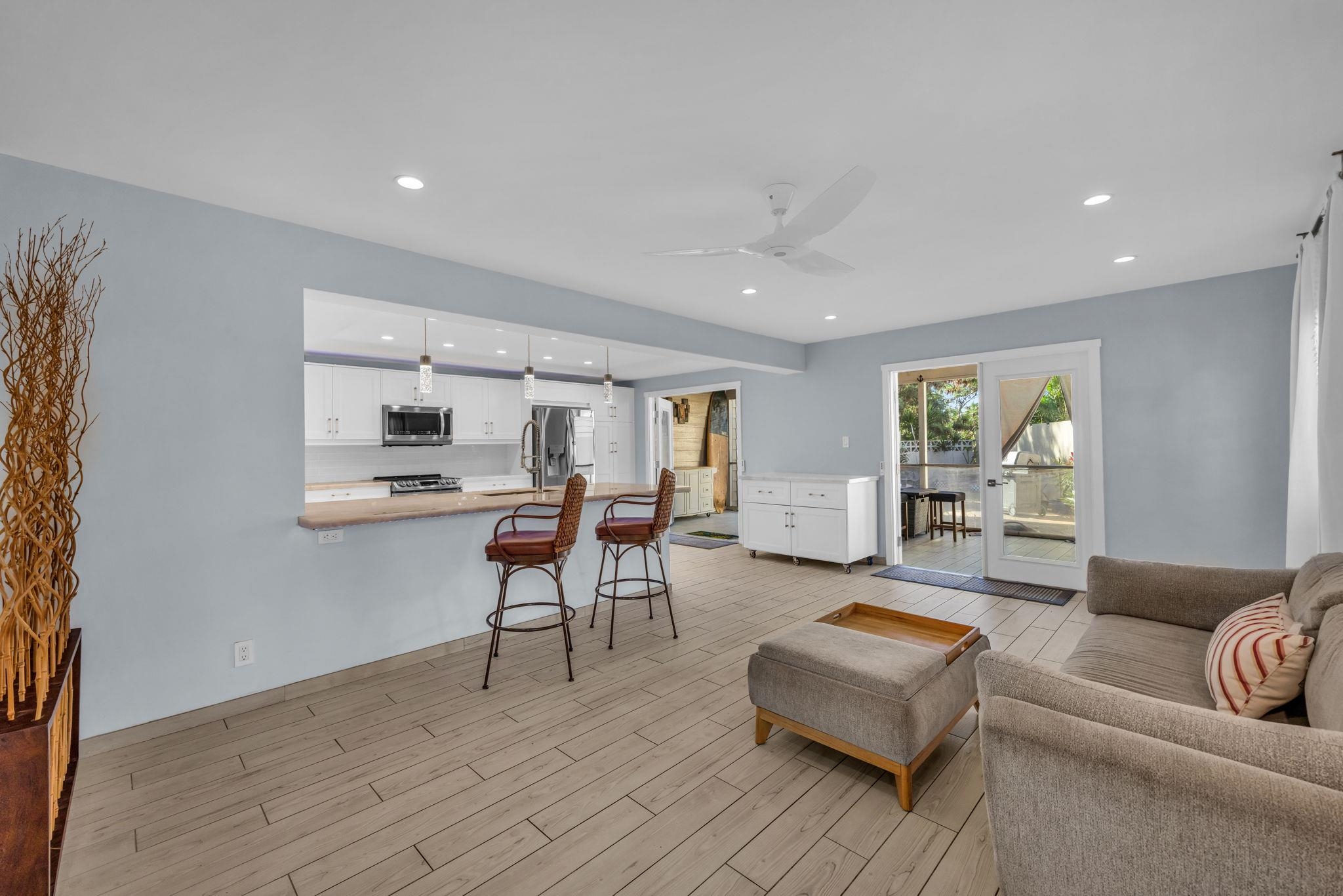 100 Auhana Road, Unit 103 Kihei, HI 96753 - Photo 5 of 43 a living room with furniture and a wooden floor