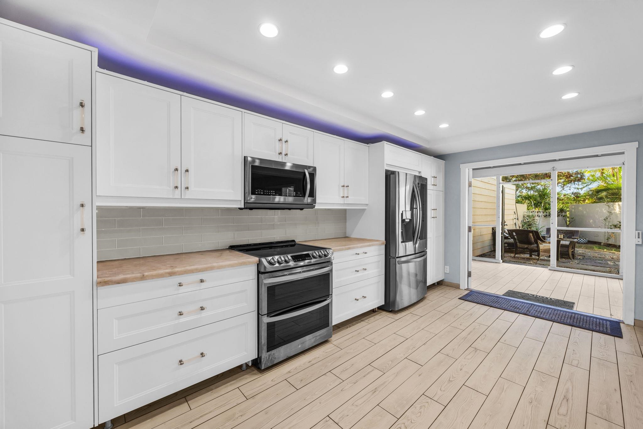100 Auhana Road, Unit 103 Kihei, HI 96753 - Photo 9 of 43 a kitchen with stainless steel appliances granite countertop a stove a sink and a refrigerator