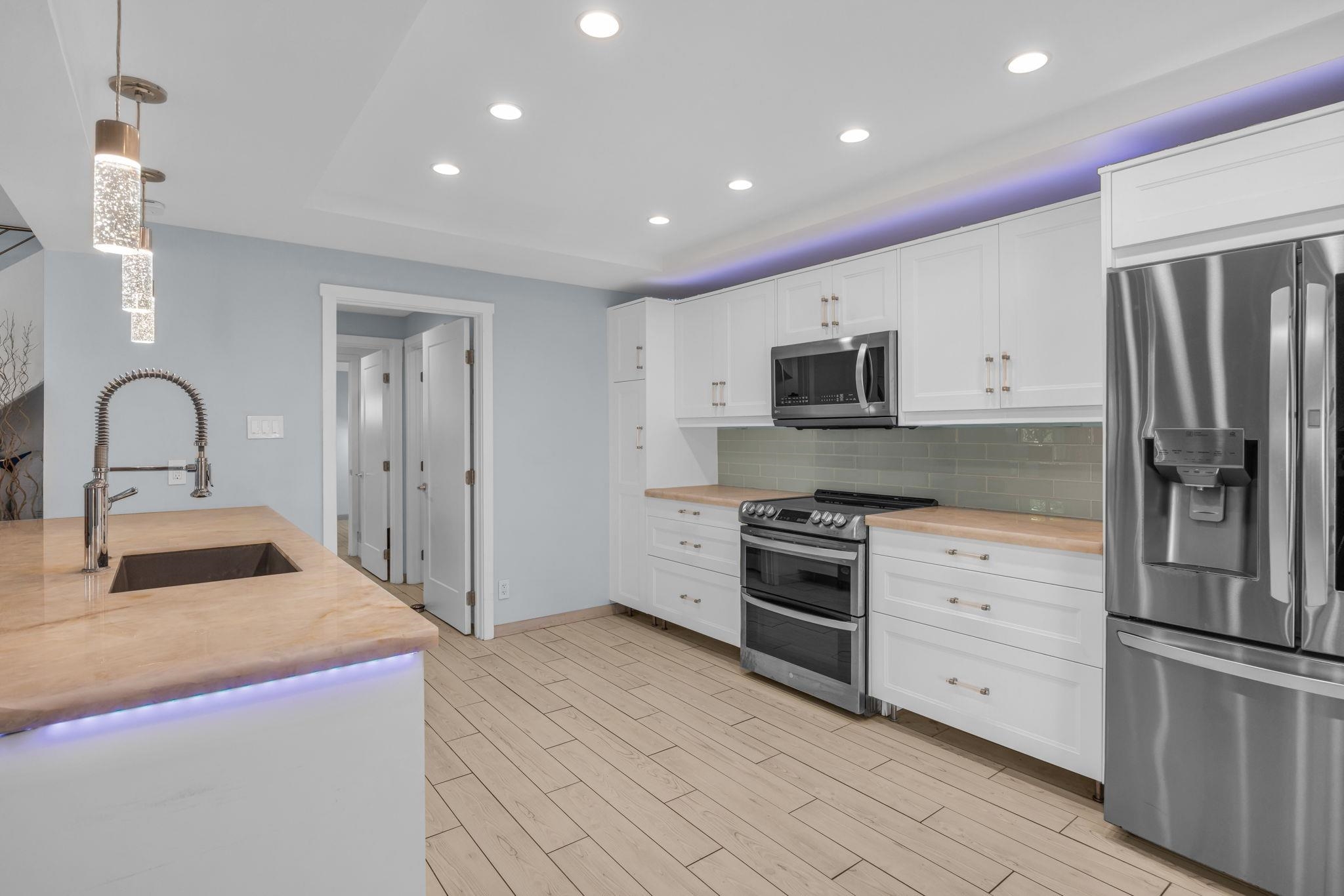 100 Auhana Road, Unit 103 Kihei, HI 96753 - Photo 10 of 43 a kitchen with stainless steel appliances granite countertop a refrigerator and a stove top oven