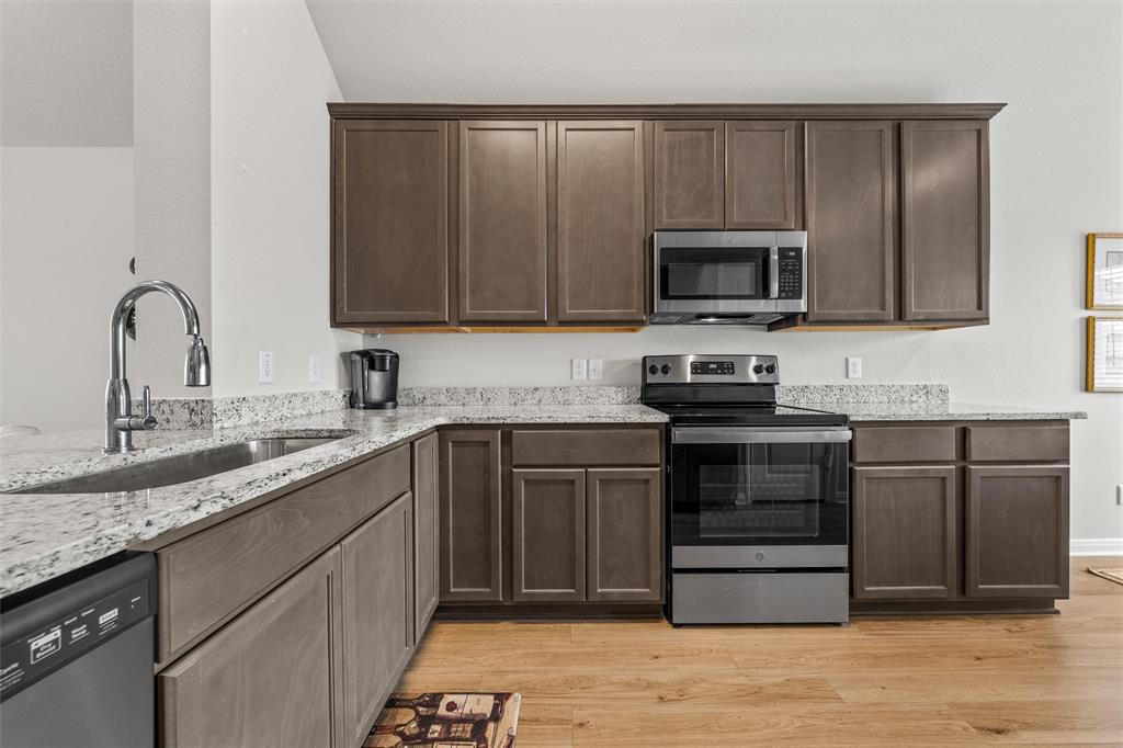 4056 Centerfire Road Waco, TX 76705 - Photo 5 of 27 a kitchen with sink cabinets and stainless steel appliances