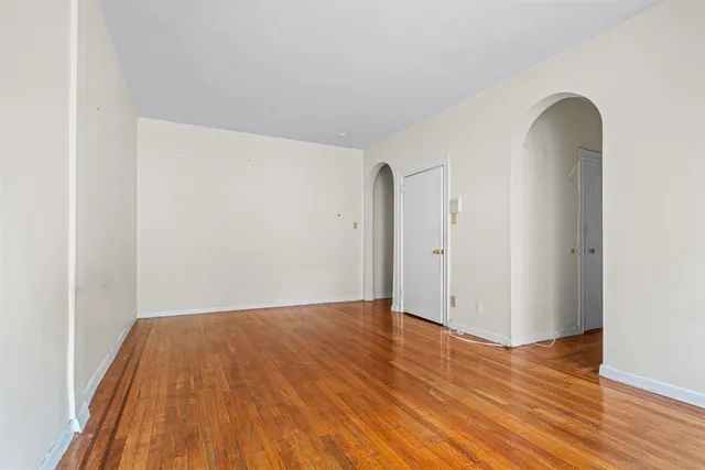 a view of a room with wooden floor