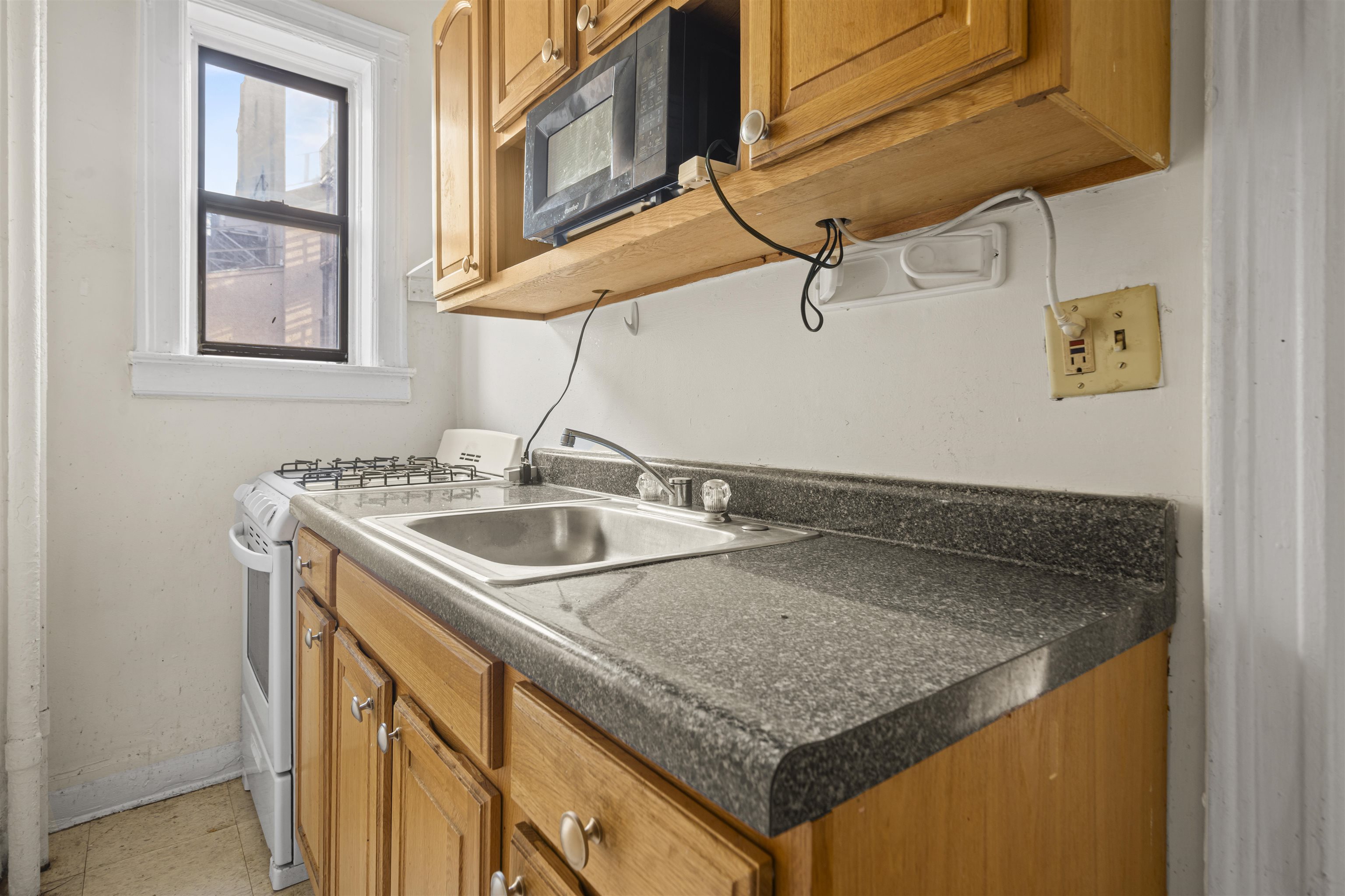 821 Bergen Avenue, Unit B5 Jersey City, NJ 07306 - Photo 6 of 13 a utility room with a sink and a window