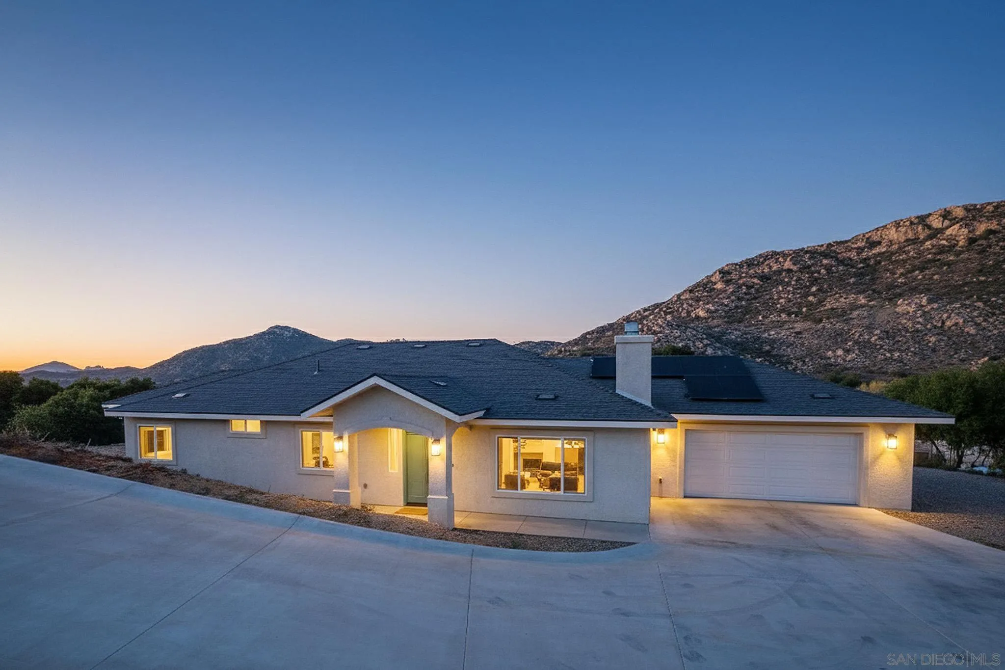 a view of house with a yard and a large window
