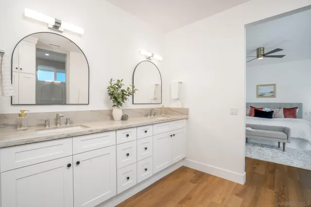 a bathroom with a double vanity sink and a mirror