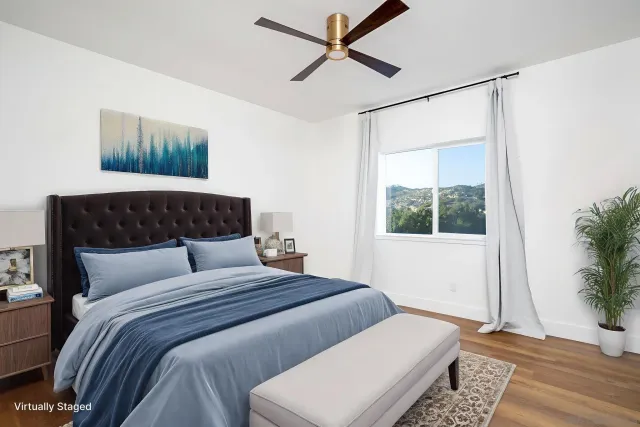 a bedroom with a large bed and a window