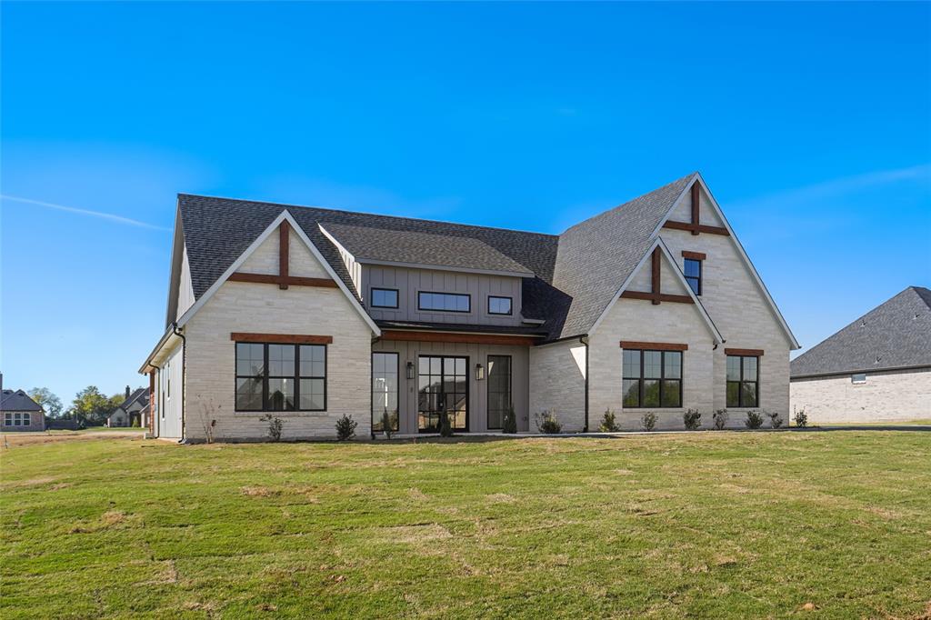 207 Stuart Street Paradise, TX 76073 - Photo 2 of 30 a front view of a house with a garden