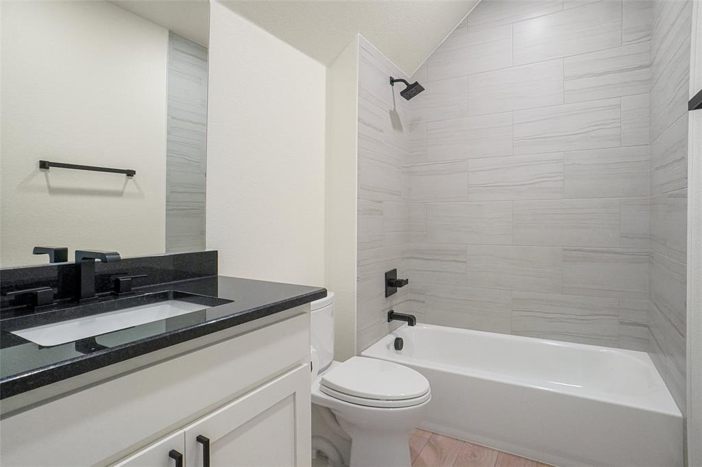 207 Stuart Street Paradise, TX 76073 - Photo 25 of 30 a bathroom with a sink a toilet and bathtub