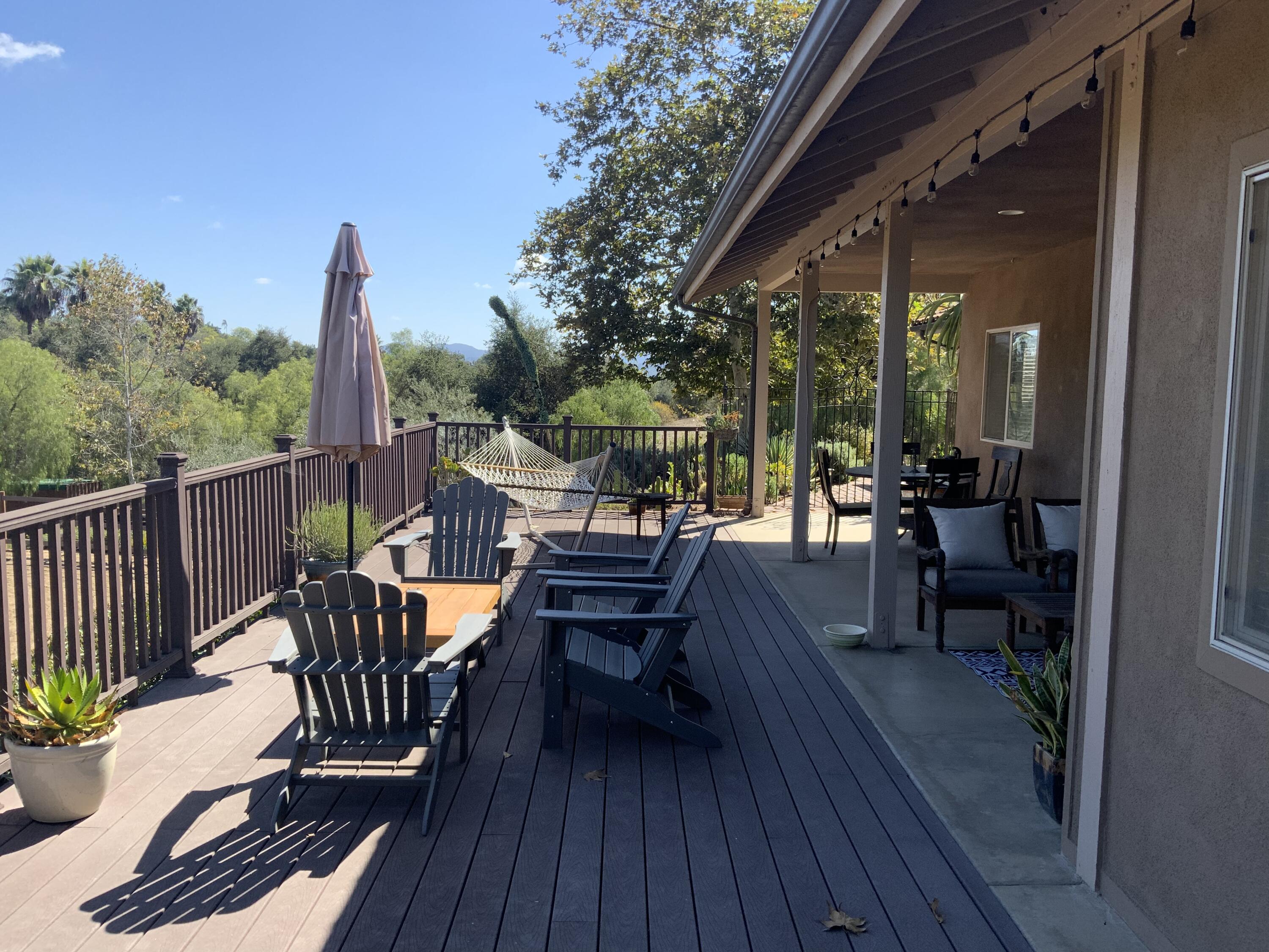 3705 La Canada Road Fallbrook, CA 92028 - Photo 18 of 68 a view of a patio with a dining table and chairs with wooden floor and fence