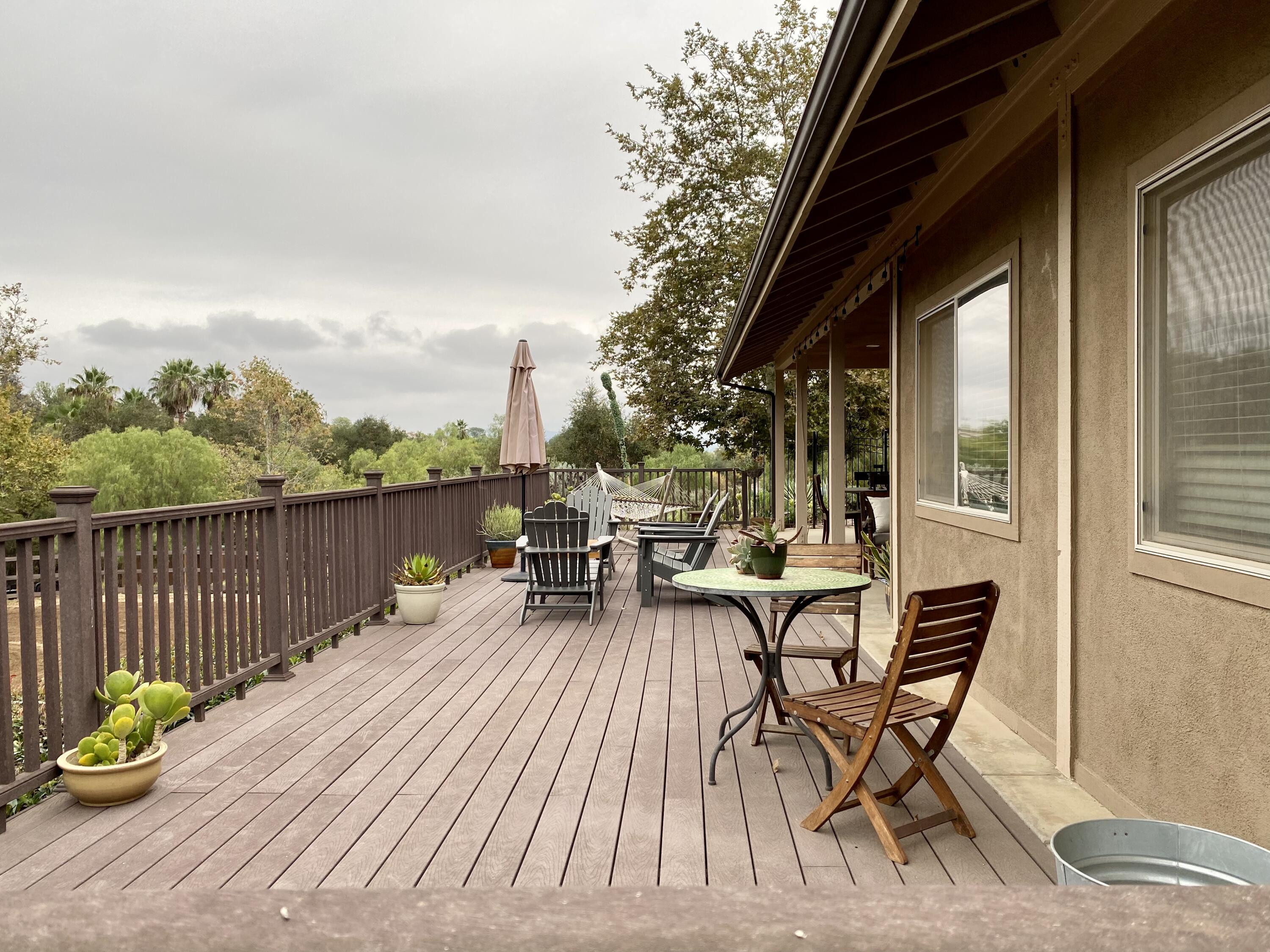 3705 La Canada Road Fallbrook, CA 92028 - Photo 61 of 68 a view of a patio with a table and chairs and wooden floor