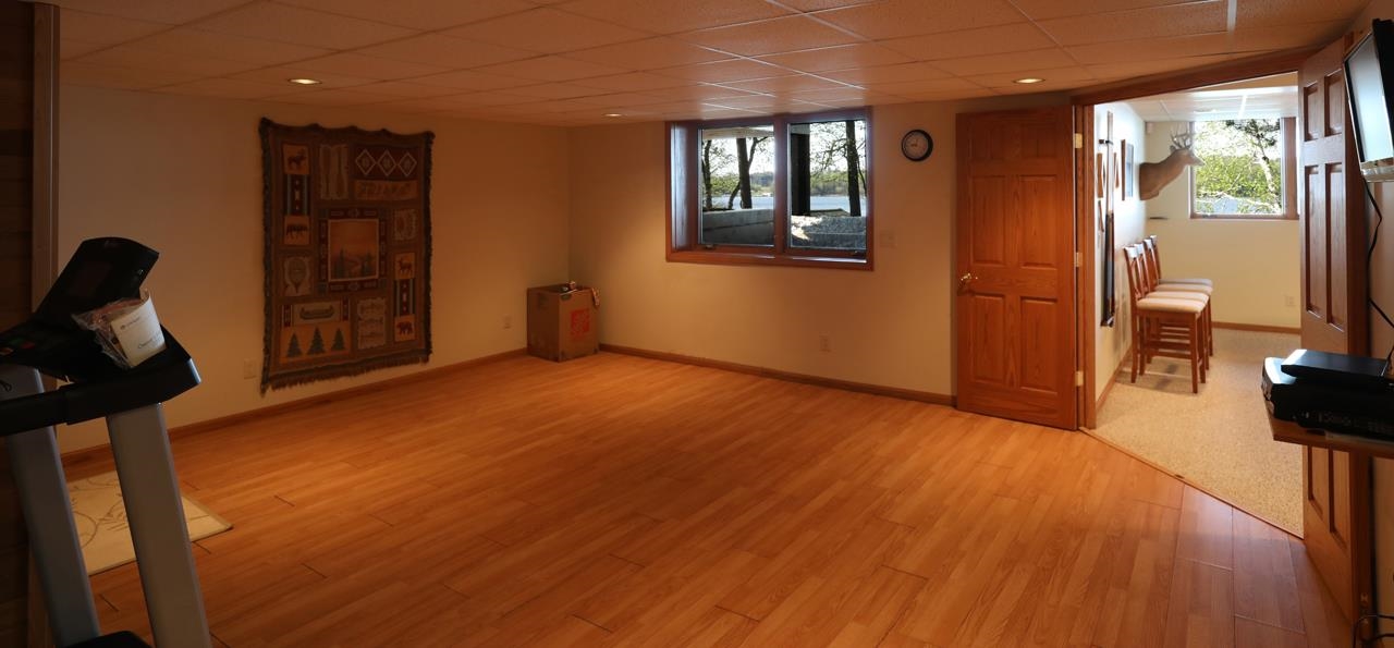 1880 Everett Bay Road Tower, MN 55790 - Photo 23 of 50 Below grade area with a drop ceiling, plenty of natural light, light wood finished floors, and baseboards