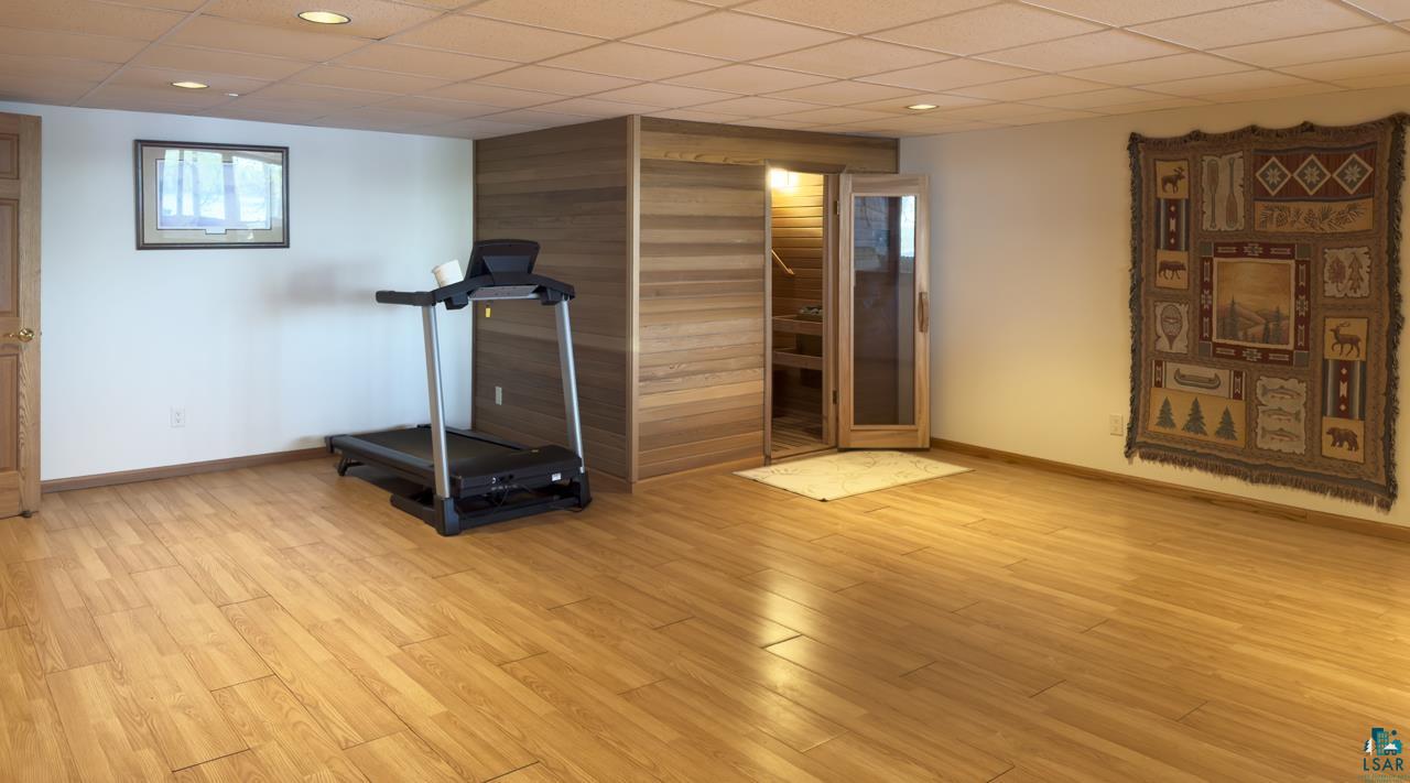 1880 Everett Bay Road Tower, MN 55790 - Photo 24 of 50 Workout room featuring baseboards, light wood-type flooring, wood walls, and recessed lighting