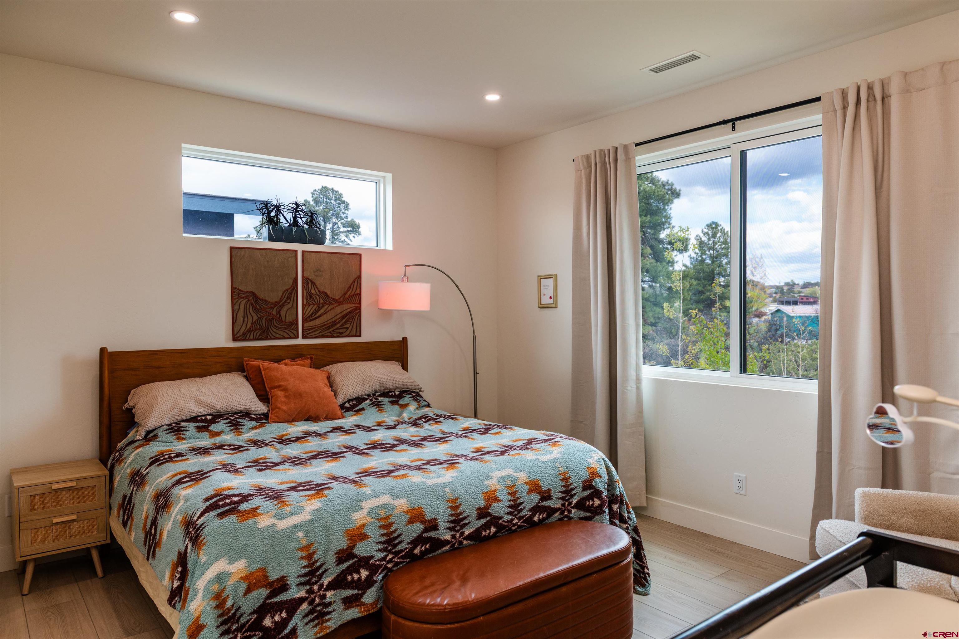 101 Elevation Drive Durango, CO 81303 - Photo 12 of 25 a bedroom with a large bed and a window