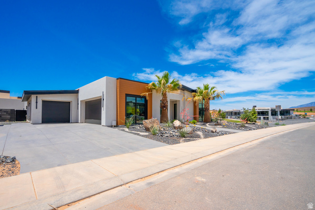 3606 South Cypress Road Hurricane, UT 84737 - Photo 2 of 69 Modern home featuring an attached garage, stucco siding, and driveway