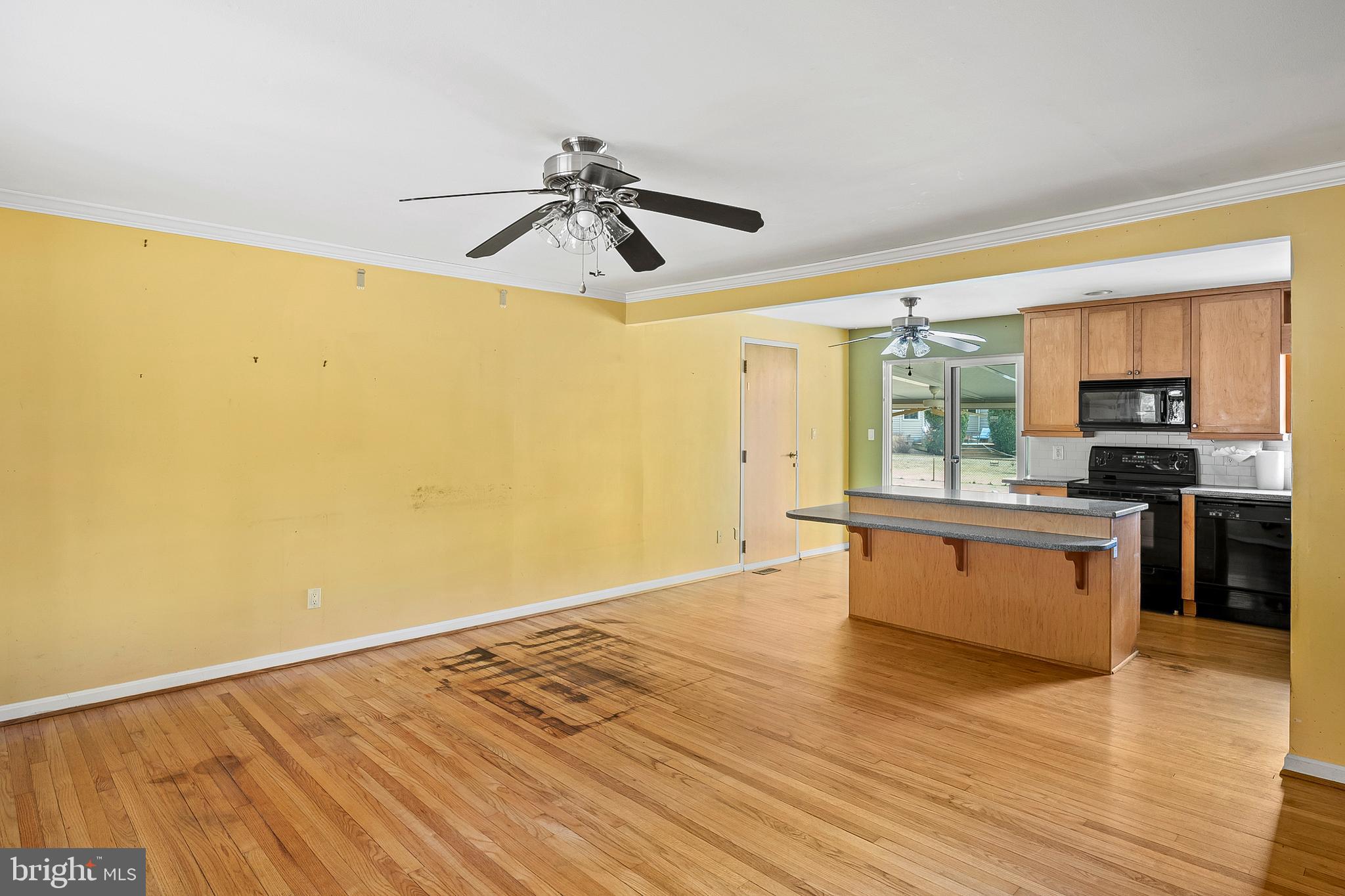 107 Holly Road Edgewater, MD 21037 - Photo 7 of 31 a view of a kitchen with wooden floor and a kitchen space