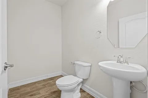 a bathroom with a sink toilet and a mirror