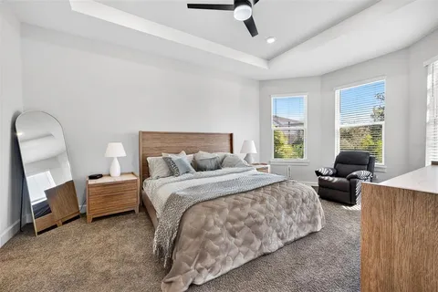 a living room with patio furniture and a floor to ceiling window
