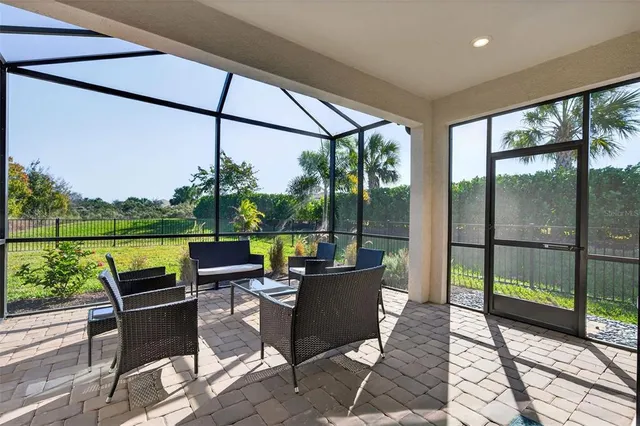 an aerial view of a house with a garden and lake view