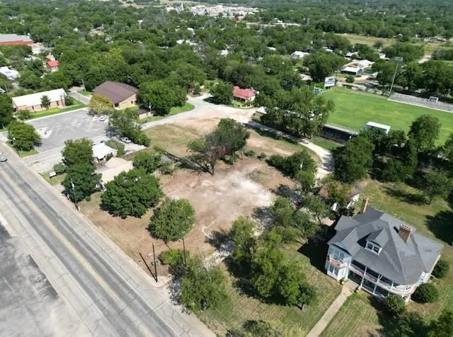 an aerial view of a house with a garden and mountain view in back