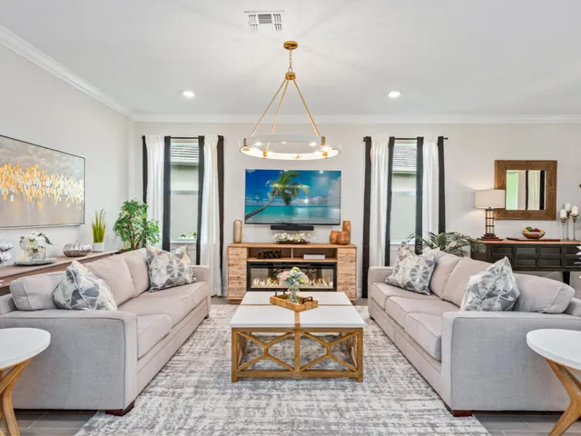 a living room with fireplace furniture and a large window