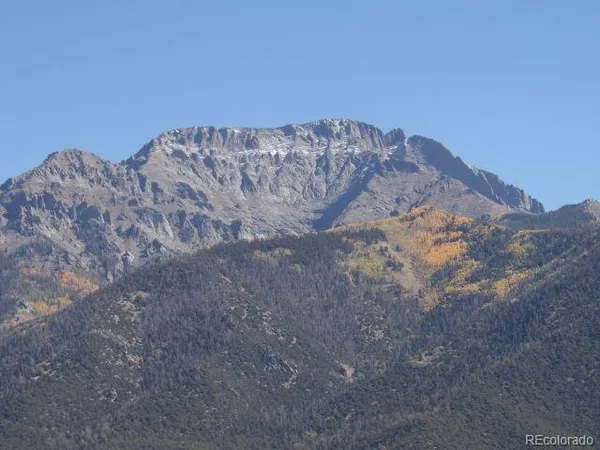 a view of a dry yard with mountains in the background