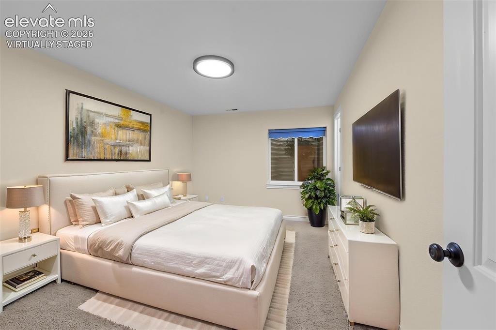16540 Mesquite Road Peyton, CO 80831 - Photo 36 of 50 a bedroom with a large bed and potted plant