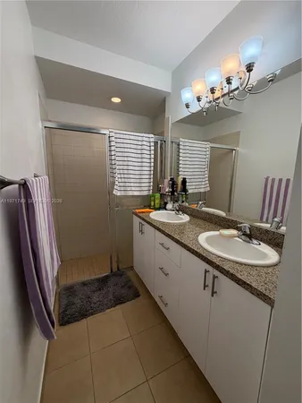 a bathroom with a sink a mirror and a shower