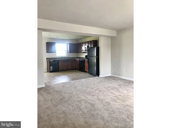 a kitchen with a refrigerator and a sink